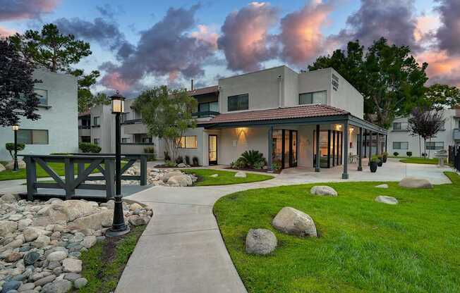 A modern house with a stone pathway leading to the front door.
