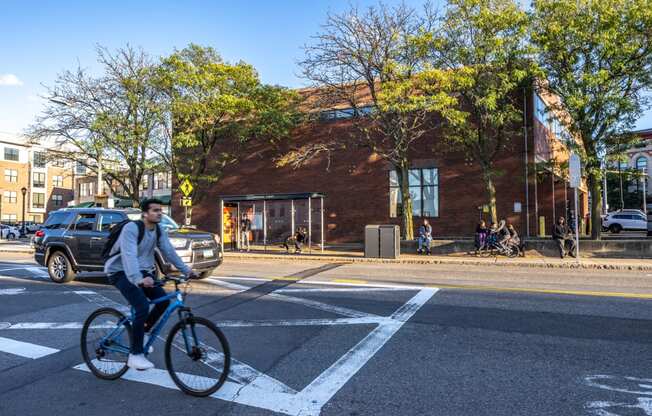 a man riding a bike in a crosswalk on a city street