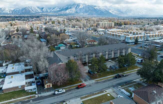 an aerial view of a city with mountains in the background