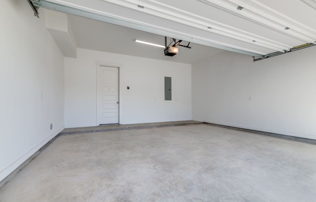 an empty room with white walls and a white door