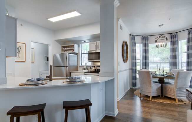 White Kitchen with counter tops, and chairs
