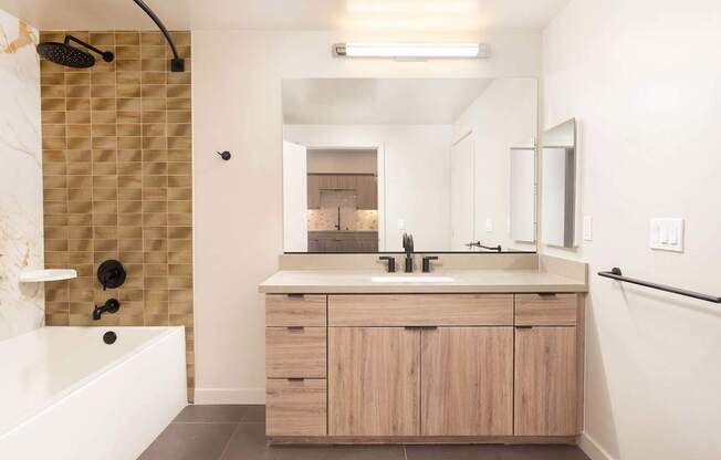 A bathroom with a shower, sink, and mirror. at Elements Apartments*, Irvine, California