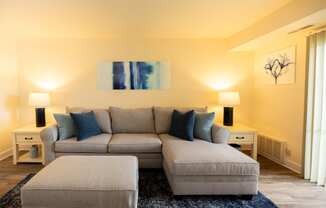 Living room with a couch and a chairat Rockdale Gardens Apartments*, Baltimore, MD