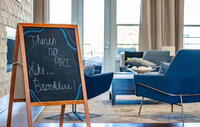 a chalkboard in a living room with a table and chairs