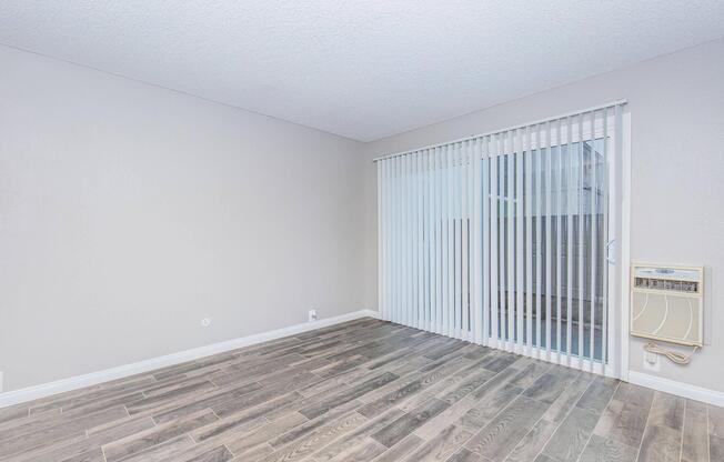 a bedroom with a building in the background