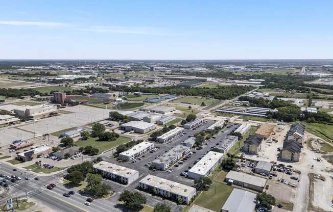 an aerial view of a city with buildings and cars at Brookside Apartments, Texas