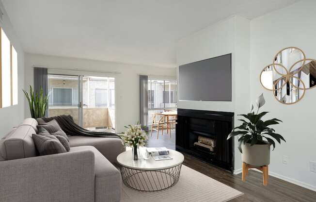 a living room with a couch and a table and a television