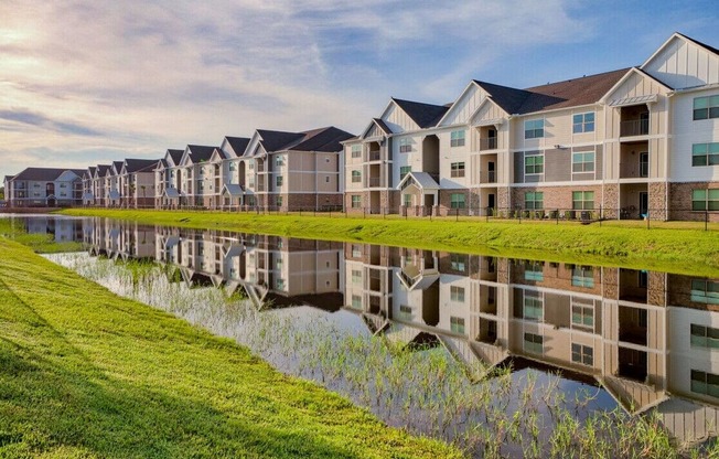 A row of modern houses are reflected in the water at Mode at Melbourne, LLC Apartments, Melbourne, FL