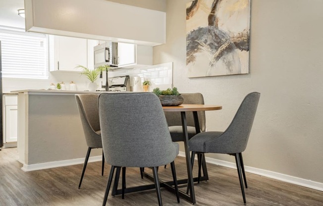 a dining room with a table and chairs