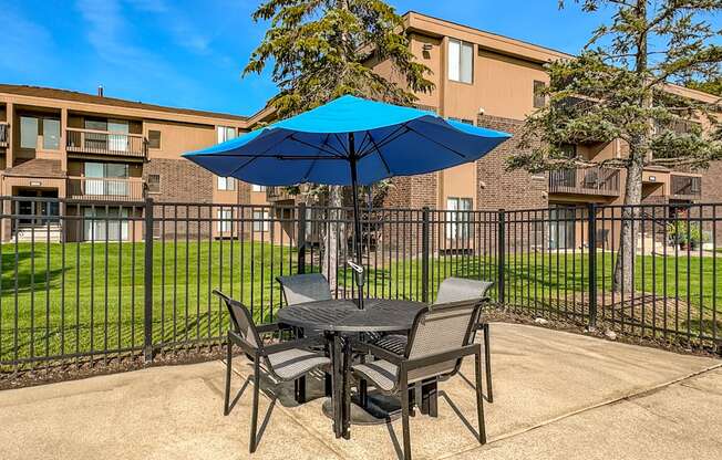Umbrella and Chairs on Sundeck at Lakeside Village Apartments in Clinton Township
