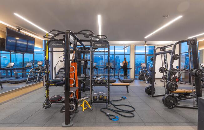 Club-quality fitness center featuring TRX and cardio equipment.