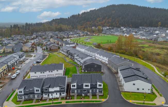 Neighborhood of houses on a street with a mountain in the background at Thrive at Green Mountain, Camas, WA, 98607