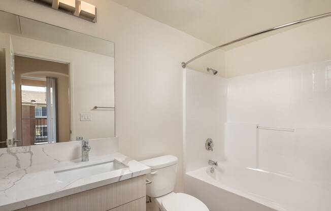 a bathroom with a sink and a toilet and a tub