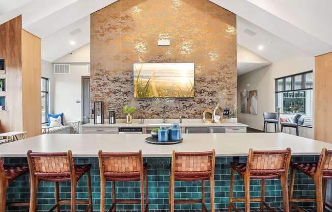 a kitchen with a large island and bar chairs