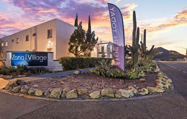 A building with a sign that says Zona Village.
