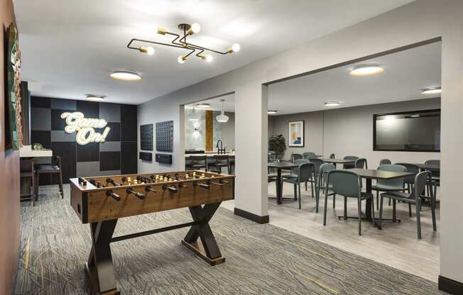 a game room with a foosball table and a tv