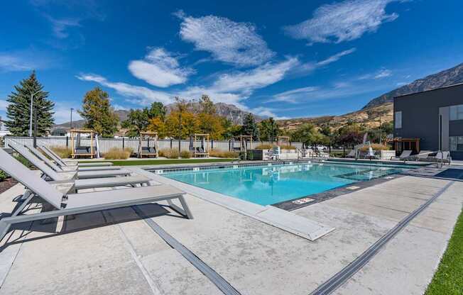 the retreat apartments apartments pool and lounge chairs with mountains in the background