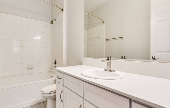 a bathroom with a sink toilet and bathtub at Arioso apartments located at 3030 Claremont Dr in Grand Prairie, TX