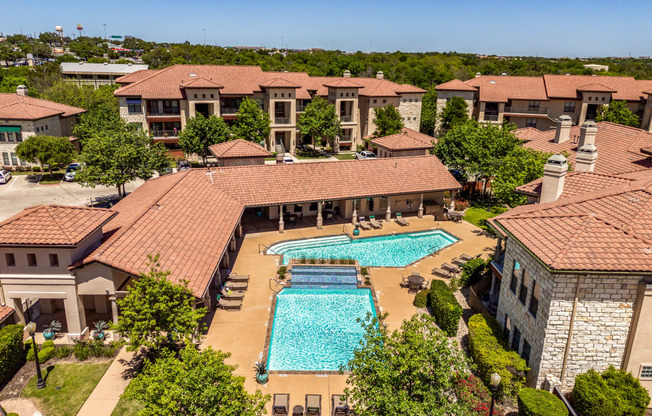 an aerial view of the pool at the resort on a sunny day