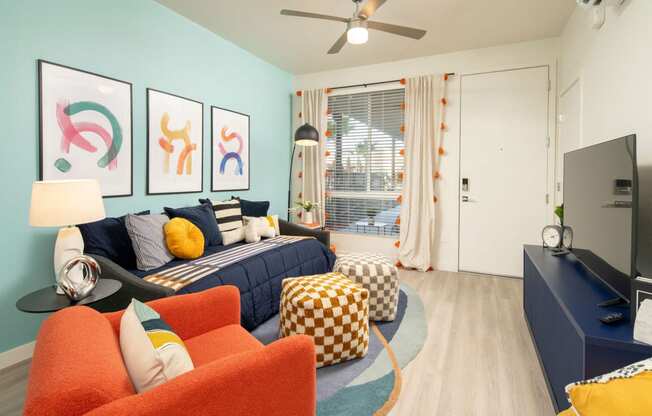 Living room and bedroom of Studio at Streamliner 16th Apartments in Phoenix Arizona