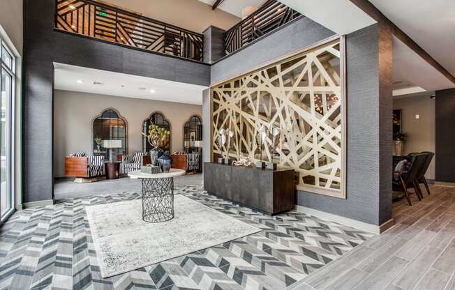 a lobby with a reception desk and a geometric design on the wall