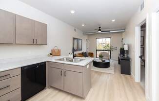 an open kitchen and living room with a sink and a table