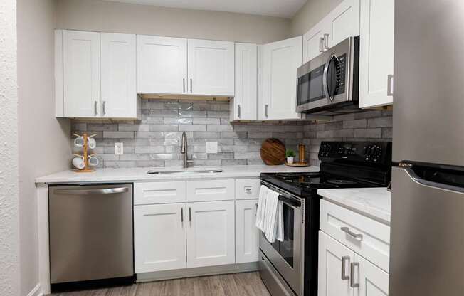 A kitchen with white cabinets at Dunwoody Glen, Georgia