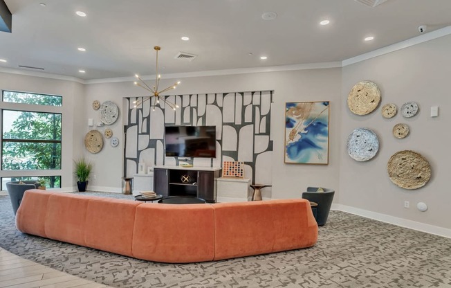 a living room with an orange couch and a fireplace