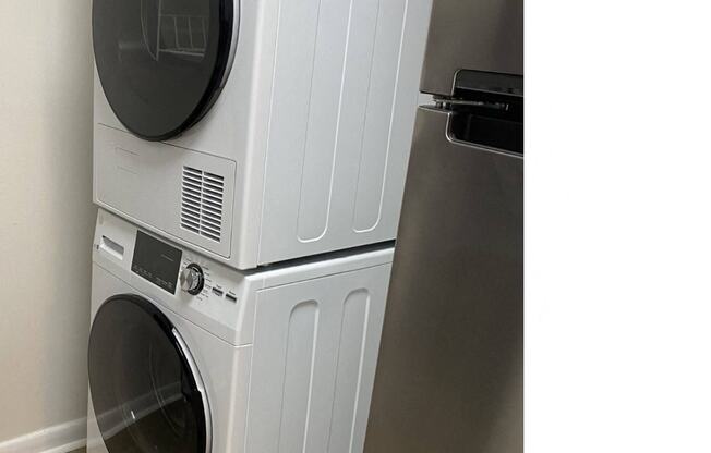 a front loading washer and dryer in a laundry room