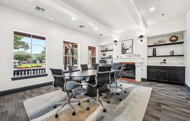 a conference room with a table and chairs and a fireplace