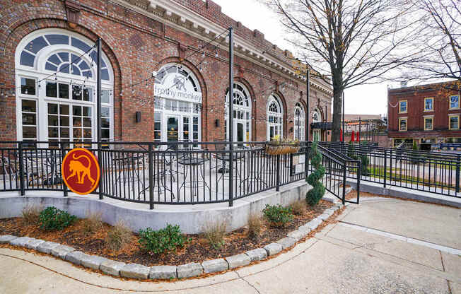 A brick building with a sign that says "Upstairs money" on it.