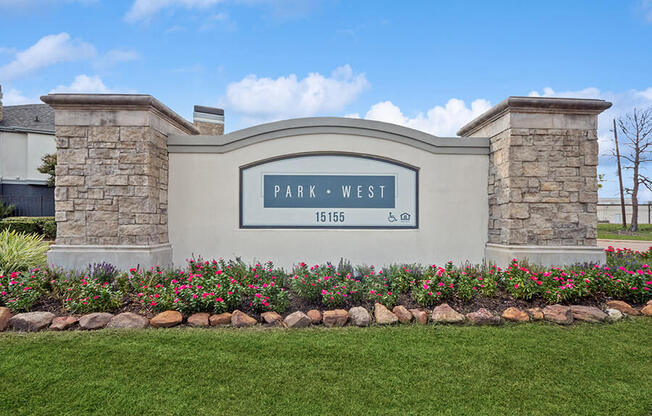 Monument Sign and Front Entrance at Park West Apartments located in Houston, TX.