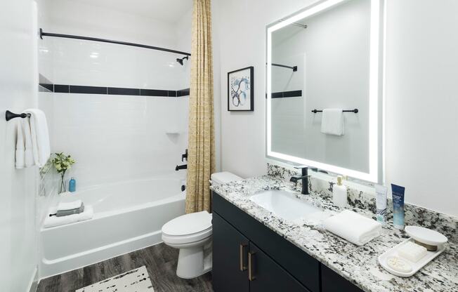 a bathroom with a shower and a sink and a toilet