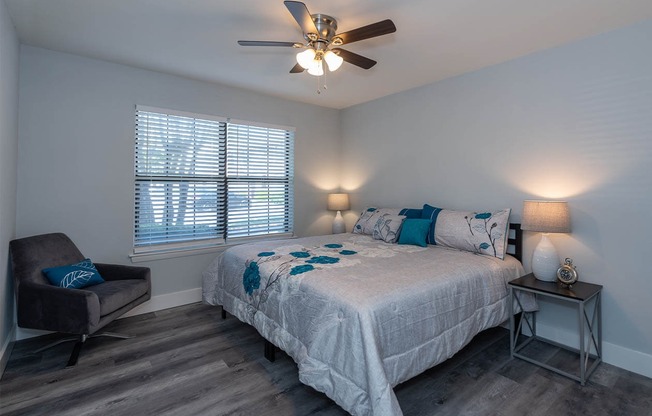 Spacious bedroom with large window and hardwood style floors at Reserves at Tidewater