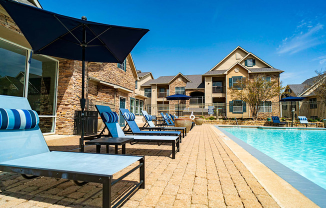 the reflection of a swimming pool with chairs on it