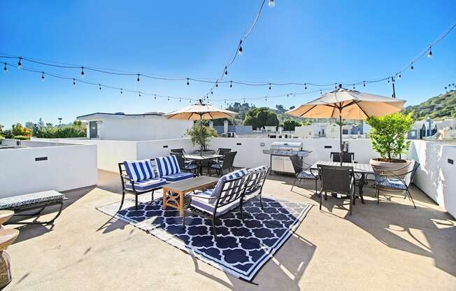 a patio with chairs and tables and umbrellas