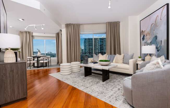 a living room with a couch and a coffee table and a large window