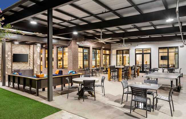 A patio with tables and chairs is set up outside a building.