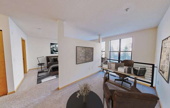 the living room of an apartment with a table and chairs