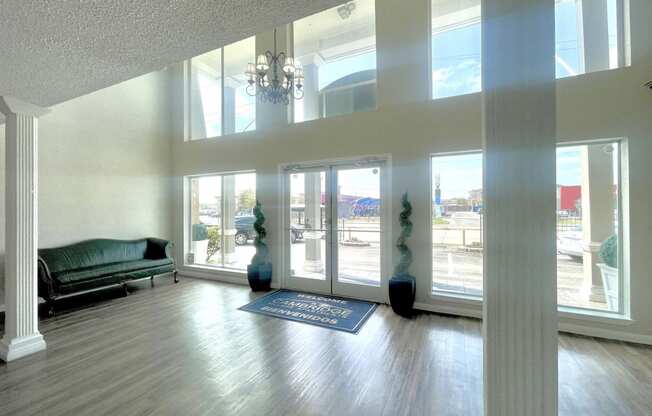 an empty living room with a couch and a chandelier at Cambridge Village Apartments, Houston, 77045 ? 