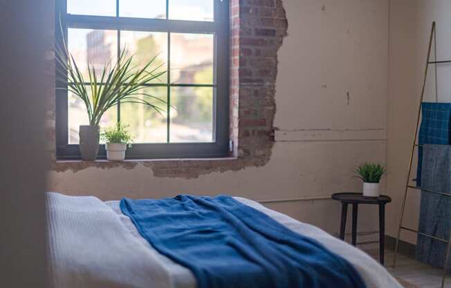 a bedroom with a bed and a window at The 22 Apartments, St. Louis, 63103