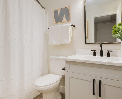 a bathroom with a toilet and a sink and a mirror