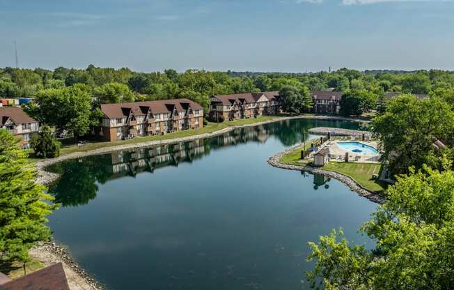 an aerial view of a lake with apartments in the background