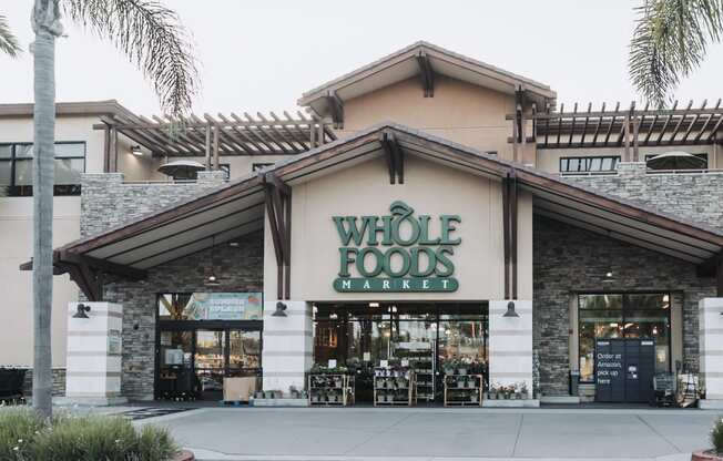 a whole foods market with a sign on the front of it