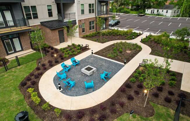 an outdoor patio with blue chairs and tables in an apartment complex