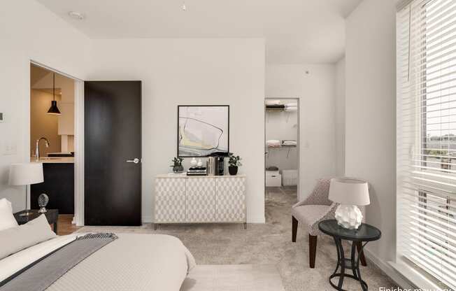 a bedroom with a bed sitting next to a window