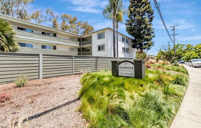 A building with a sign that says Boardwalk in front of it.