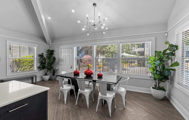 a dining room with a table and chairs and a large window