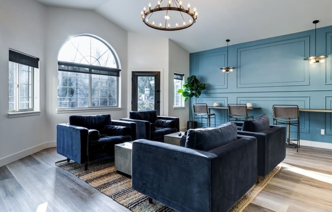 a living room with blue walls and a chandelier