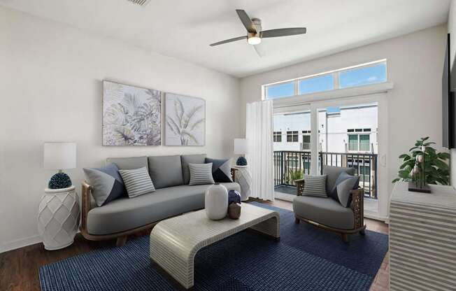 A living room with a grey couch, a white coffee table, and a ceiling fan.